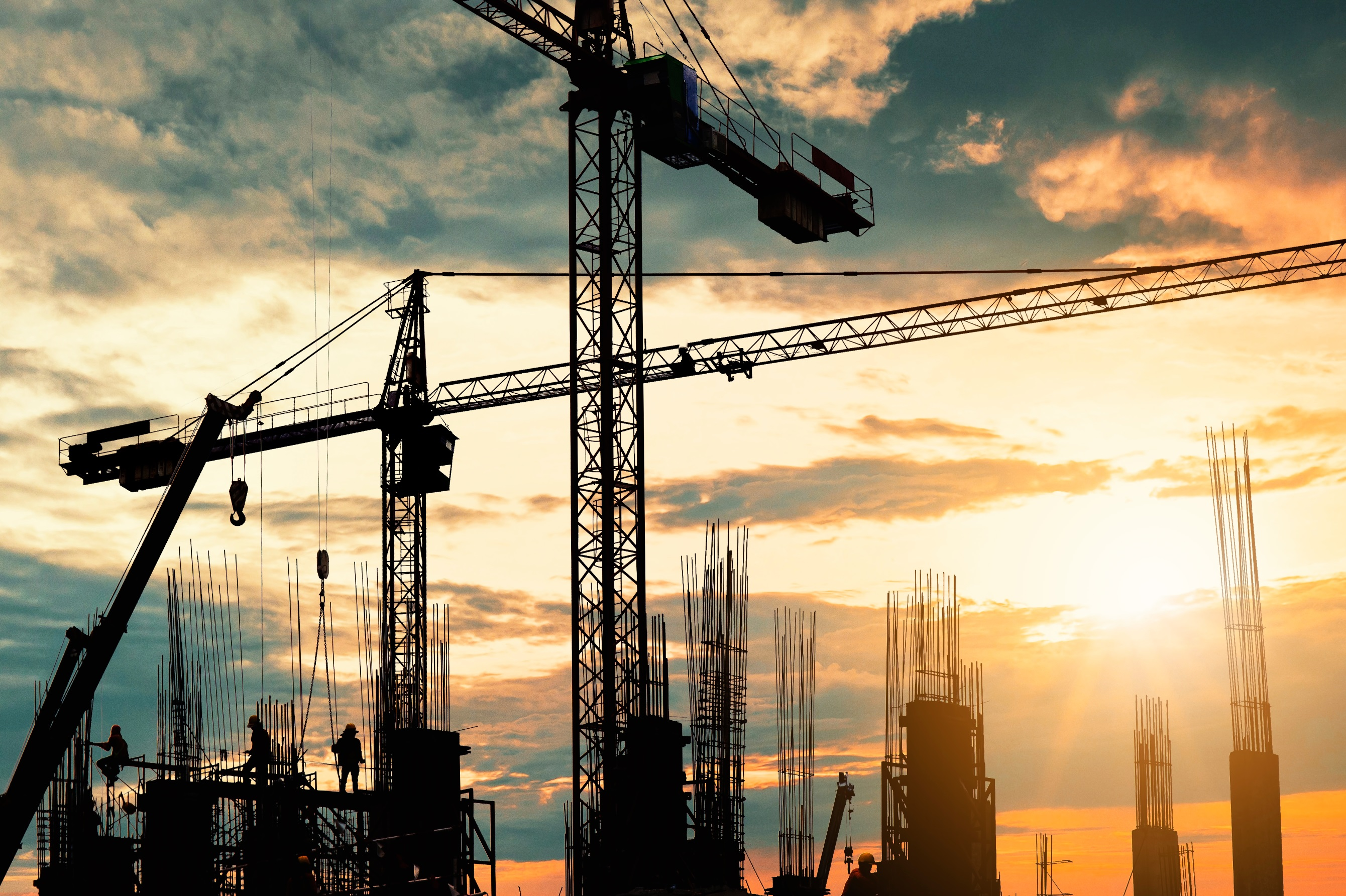 Construction crew on site at sunset